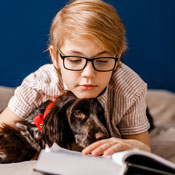 Child reading to dog
